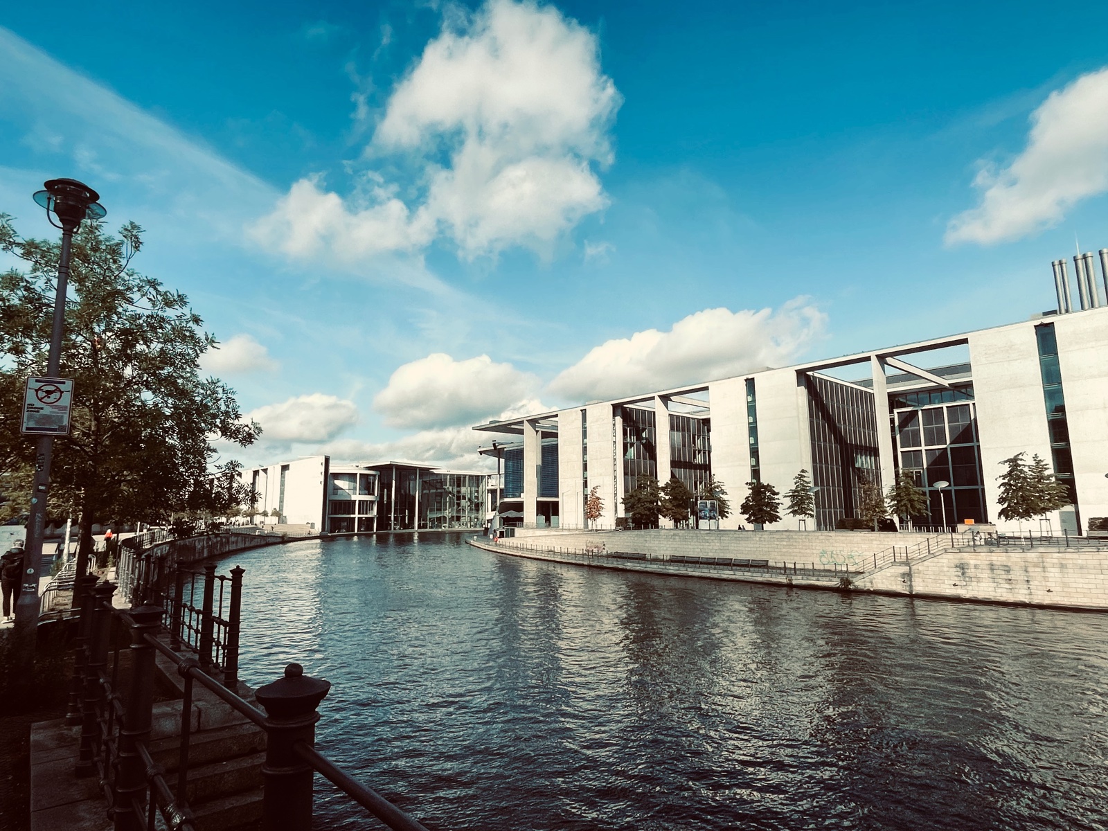 The River Spree lined with modern government buildings in Berlin under blue sky