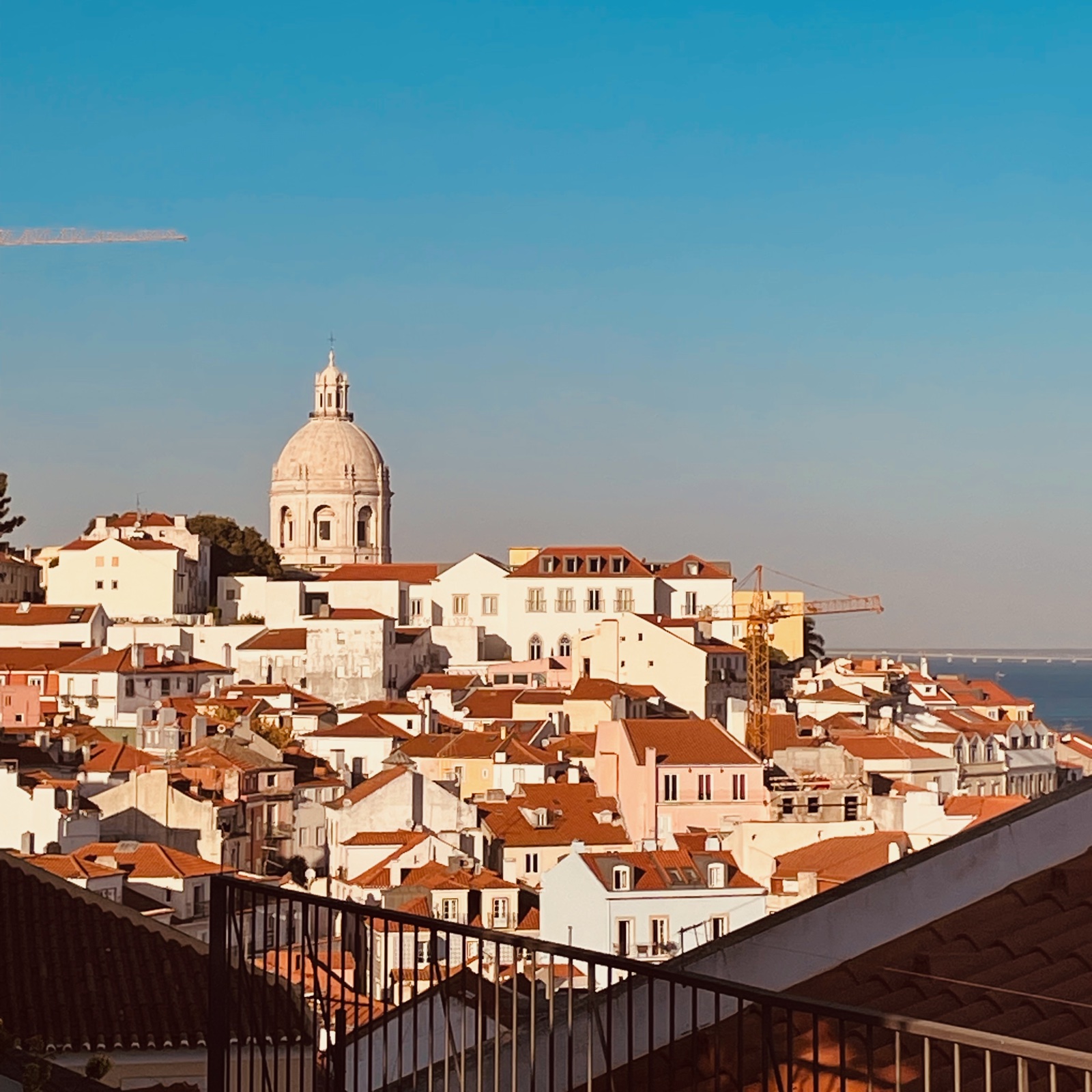 Lisbon rooftops and the white dome of the National Pantheon above the Tagus